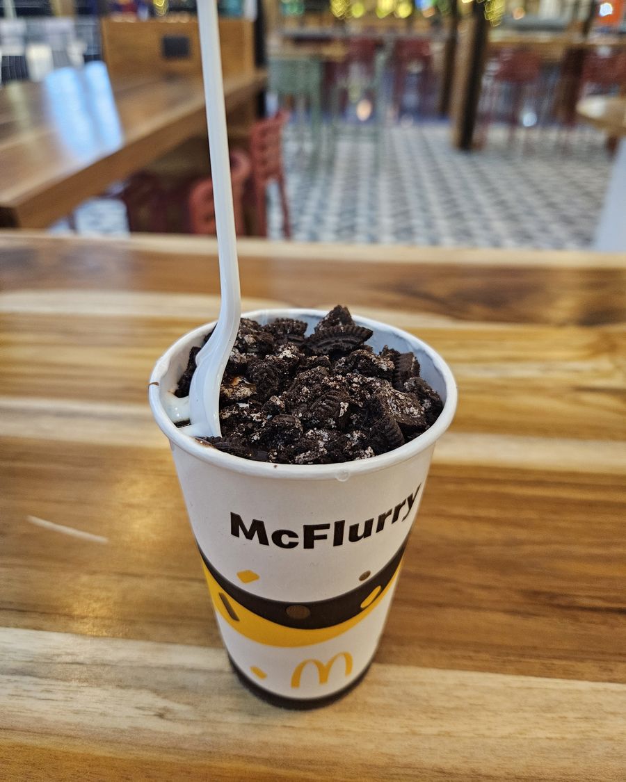 A McFlurry with cookie pieces on a wooden table