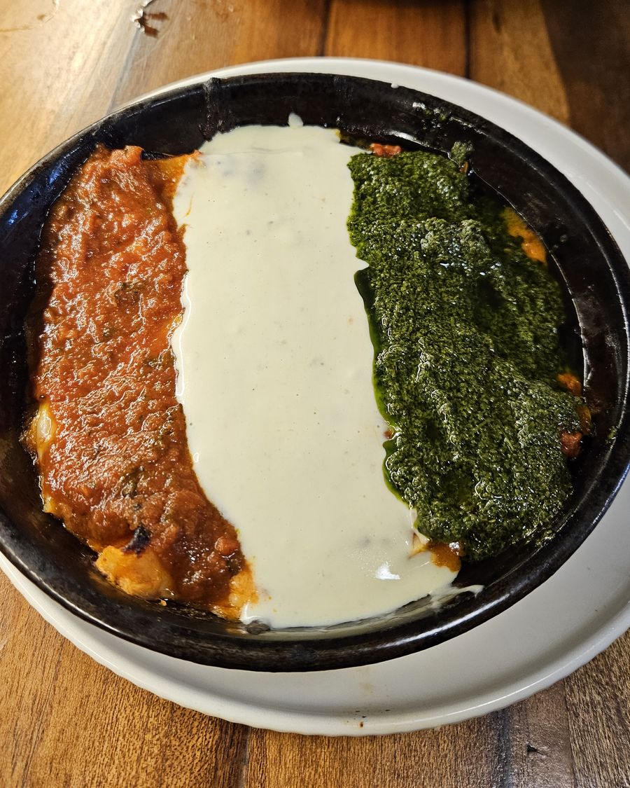 Pasticho topped with tomato sauce, white sauce and pesto